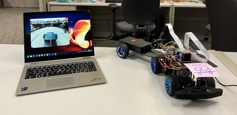 A robotic car and a computer screen showing how the car backs up
