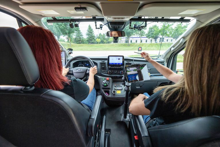 Staff members Cherie Roe and Cher Carney operate an automated Ford Transit