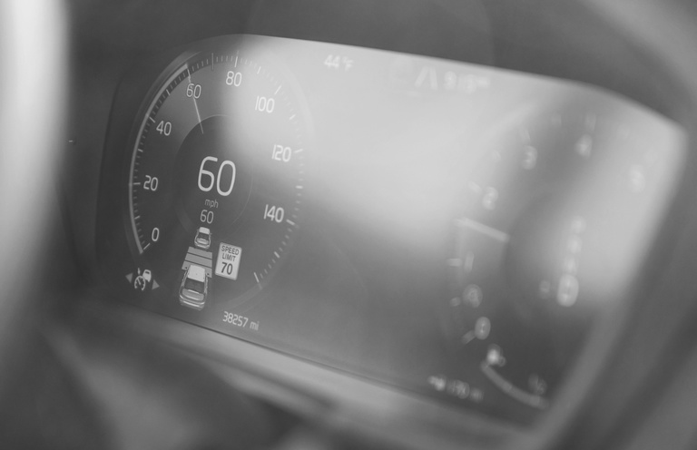 The Volvo XC90's gauge cluster showing that adaptive cruise control is enabled.