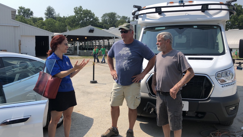Staff member Cherie Roe speaks with members of the public at the Johnson County Fair