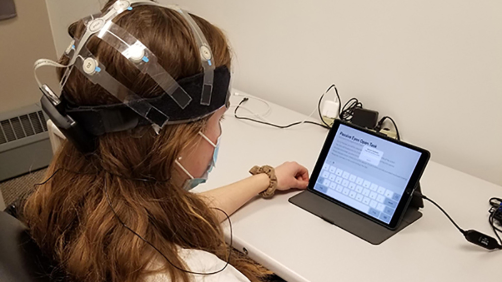 Study subject wearing a mobile, wireless X24 EEG headset and completing the Cannabis Impairment Detection Application (CIDA) on a tablet